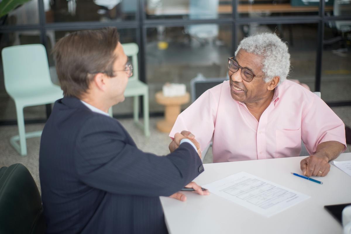 medicare-advisor-talking-to-elder-client Medicare advisor talking to elder client about lowering premium costs
